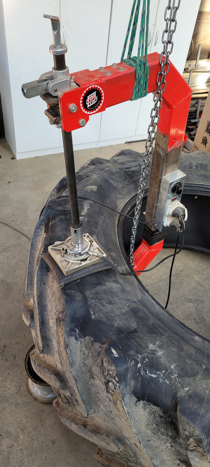 Large tractor tyre being vulcanised in the workshop
